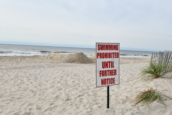 Sign of drainpipe at beach.